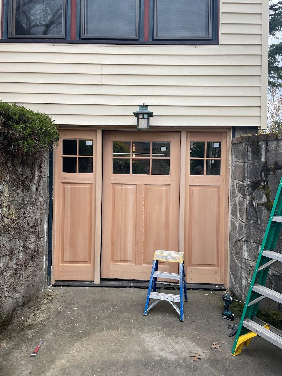 Before — raw unfinished carriage garage doors