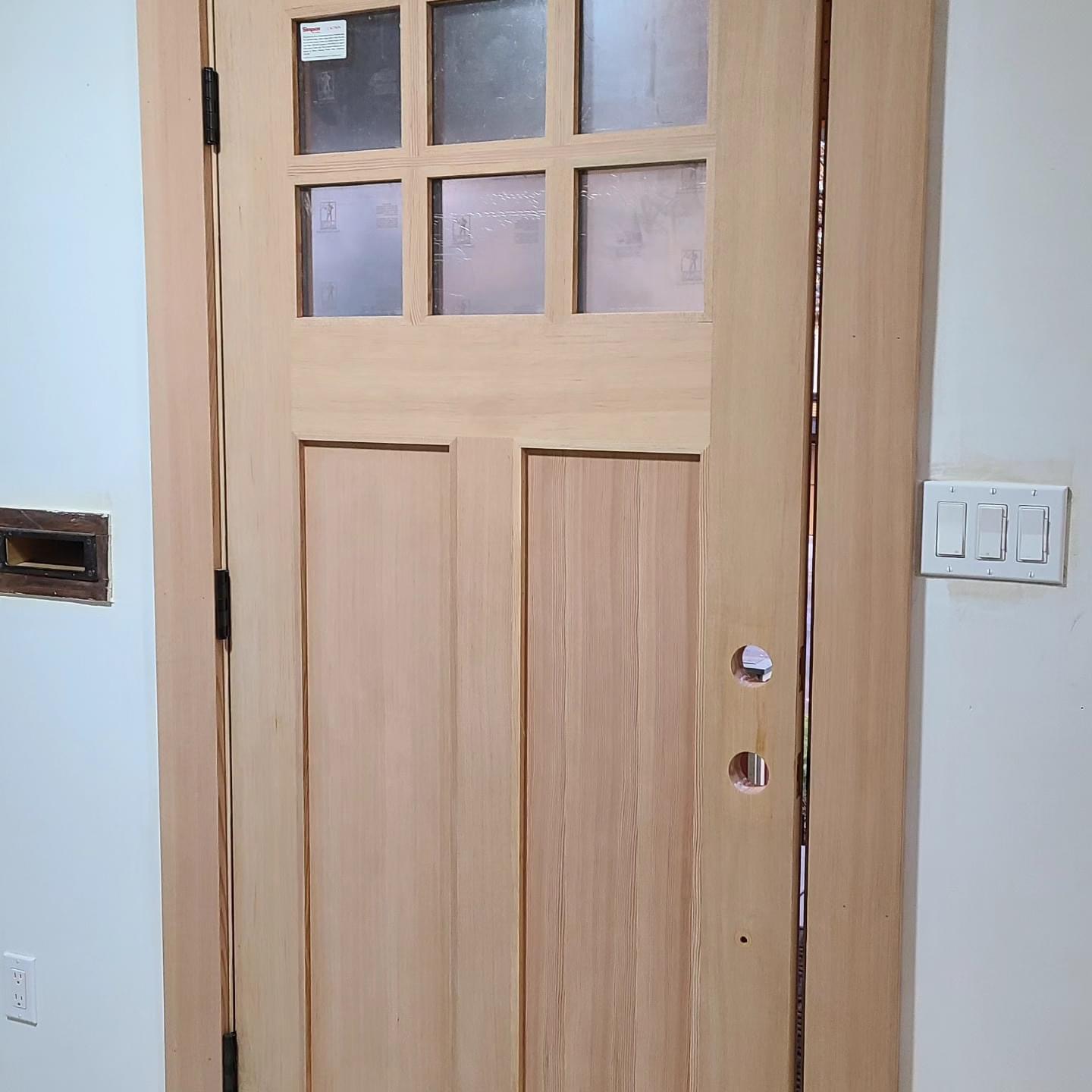 Before — unfinished craftsman door during installation