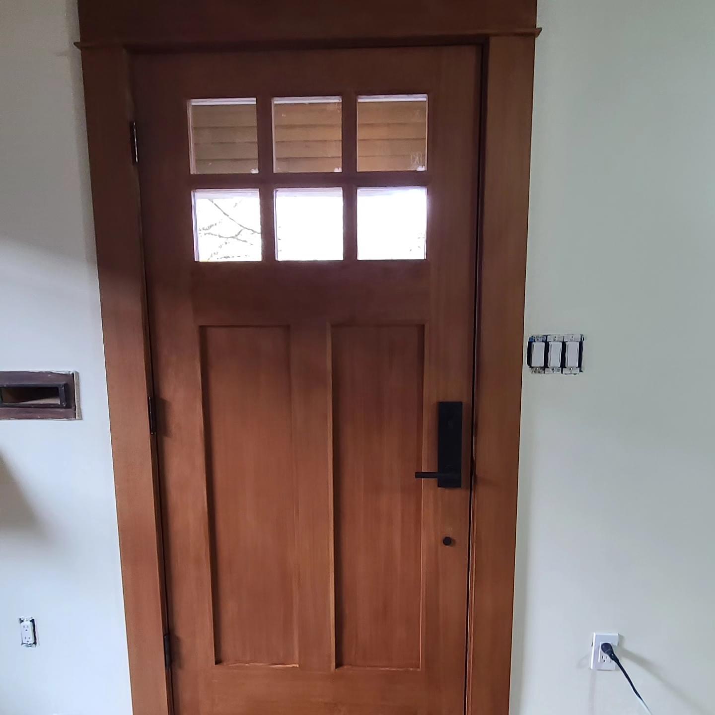 After — interior craftsman door stained with matching trim