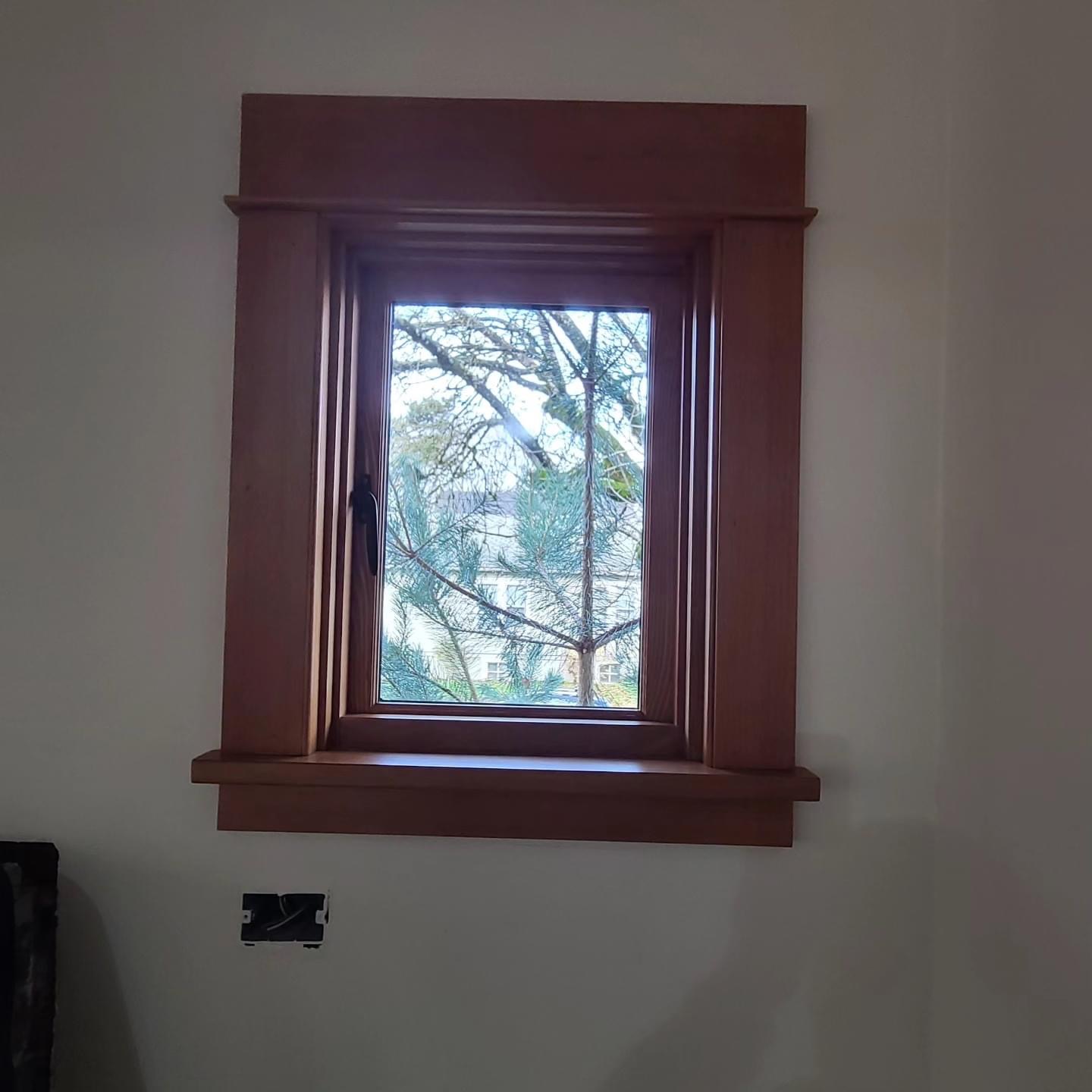 After — window and trim stained to a rich finish