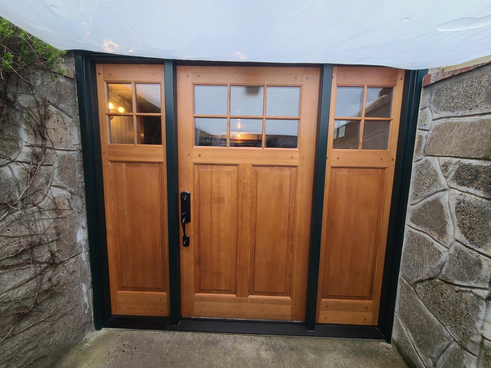 After — carriage garage doors installed and custom stained, Salem Oregon